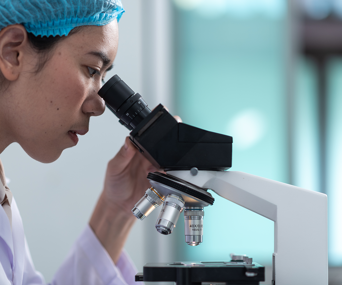 researcher using microscope Researcher using microscope